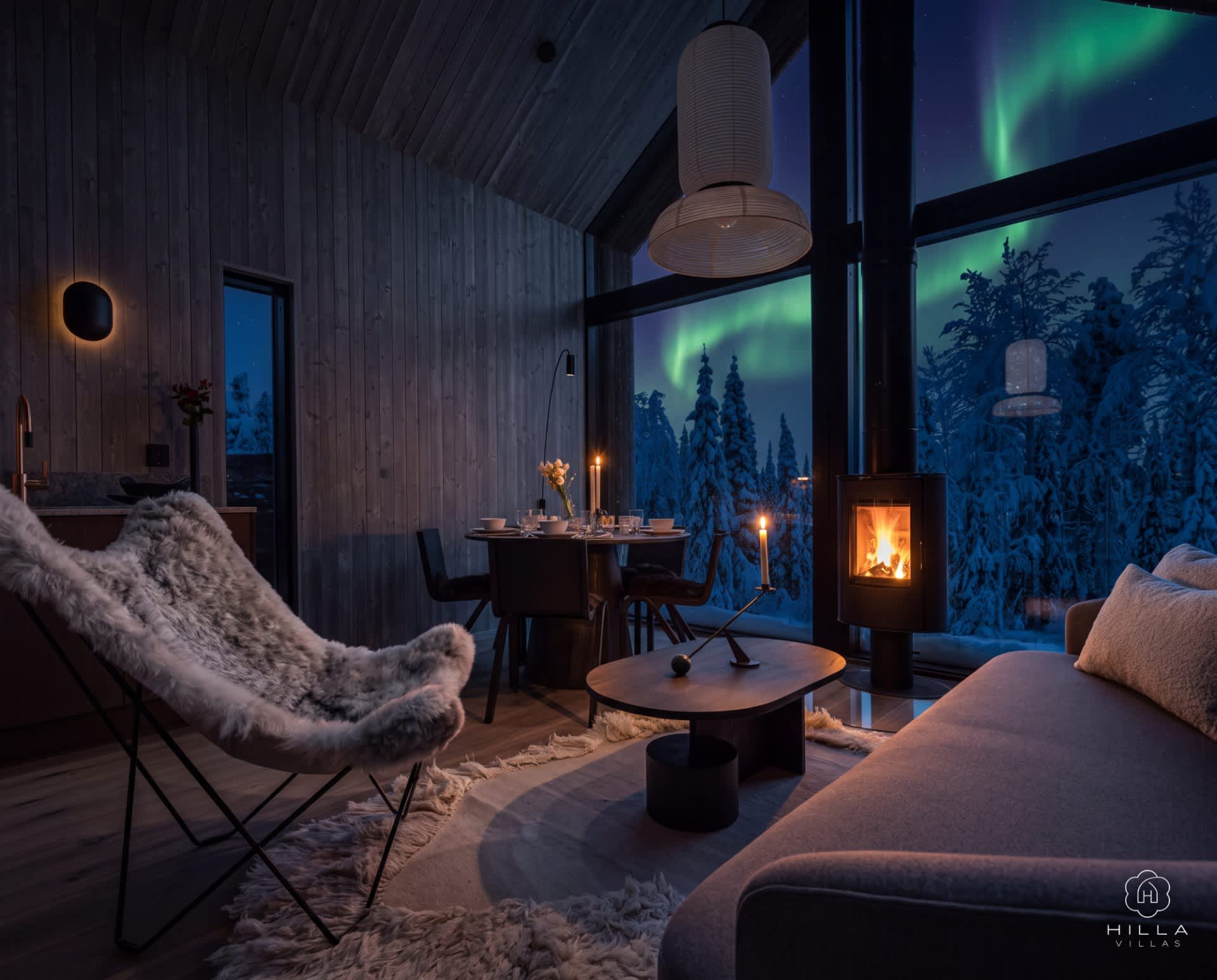 Cosy living room with a fireplace, panoramic windows and Northern Lights views